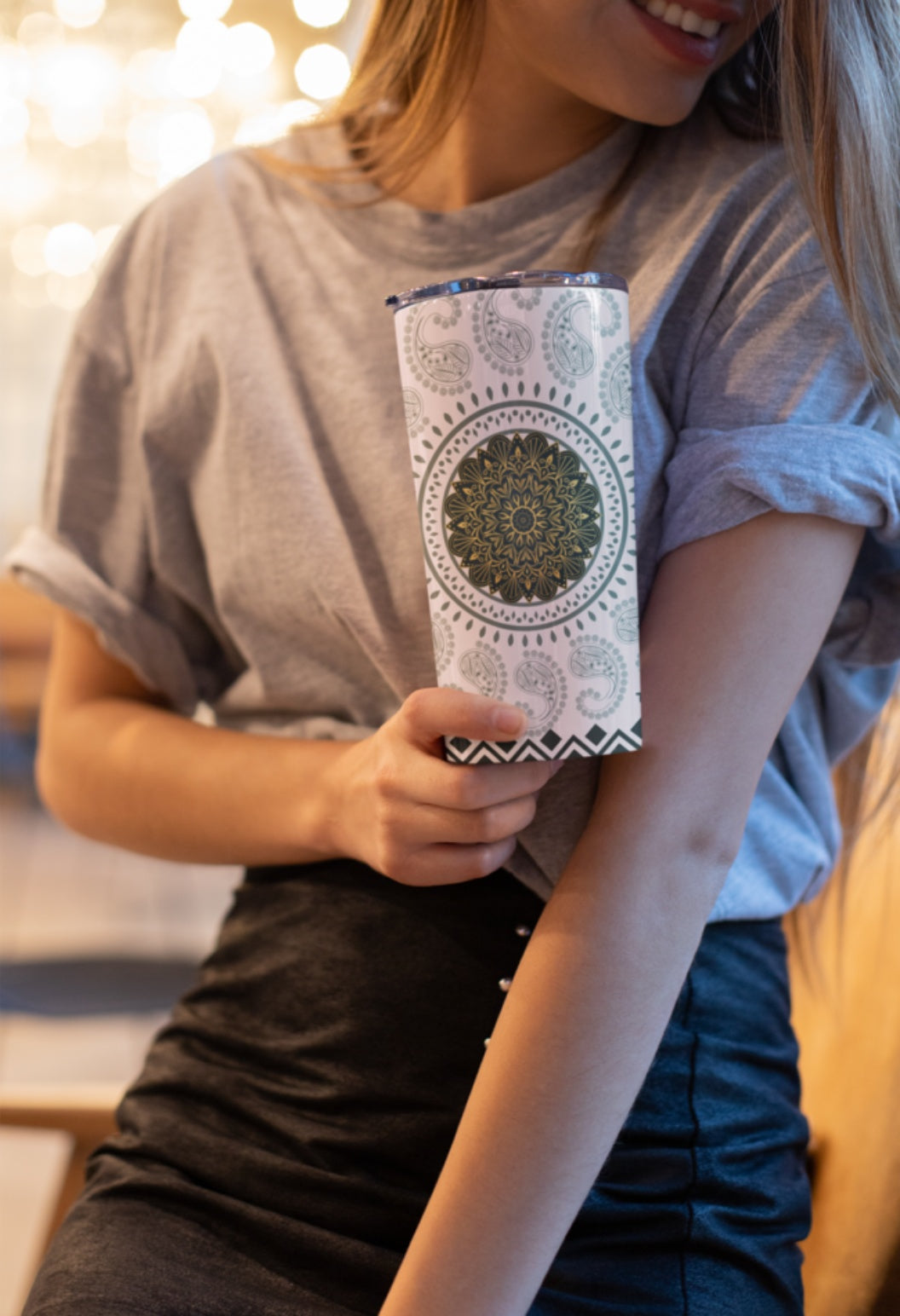 A LADY HOLDING A TUMBLER OF TRENDYATRI